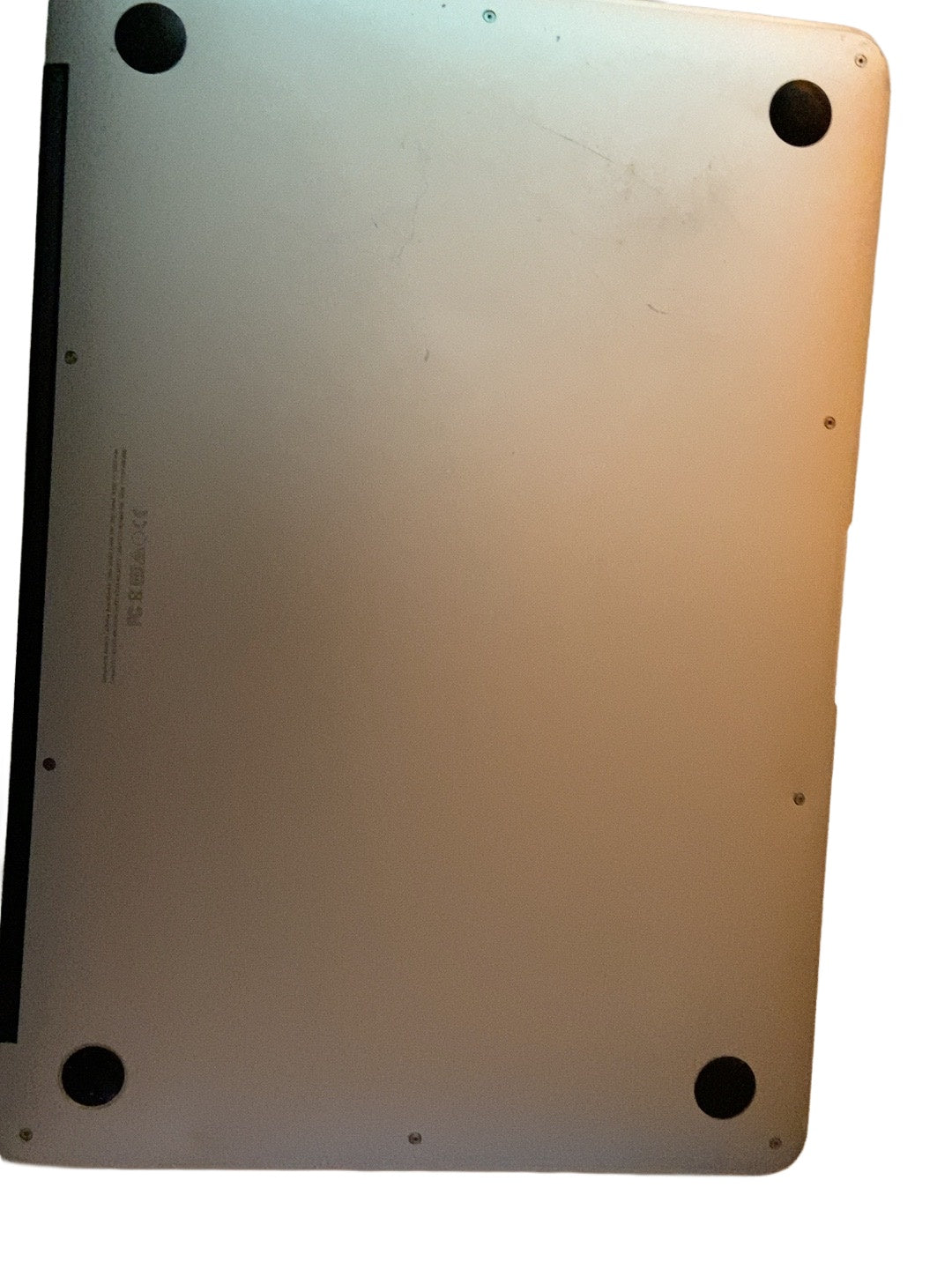 Actual Apple MacBook Air Early 2015 Core i7 underside condition on white background
